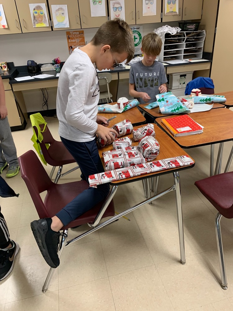 5th grade students wrapping presents