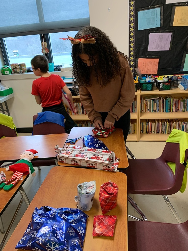 5th graders wrapping gifts
